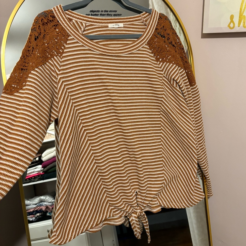 Maurice’s orange and white sweater